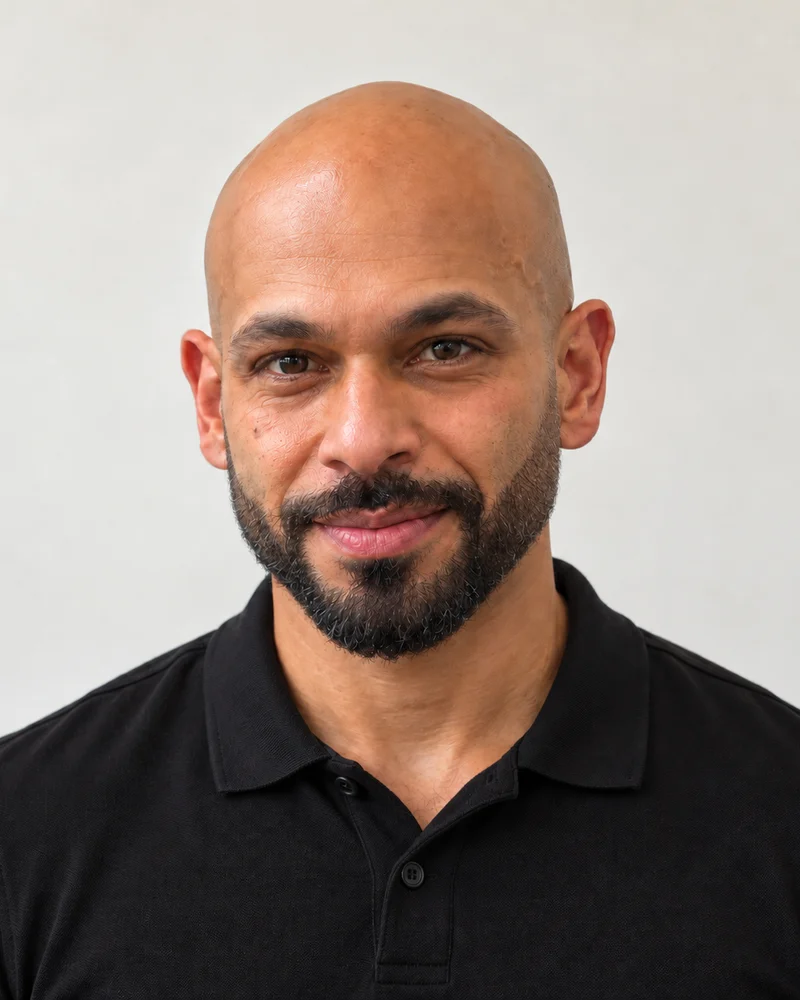 Portrait of Dr. Clive Clutton in a black polo shirt